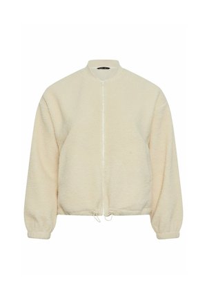Kermavan värinen fleece-takki, jossa on pyöreä pääntie, etuvetoketju ja säädettävä nyöritys helmassa. Takissa on pitkät hihat ja pehmeä, mukava tekstuuri.