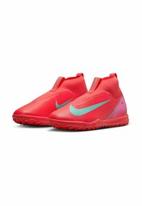 Punaiset urheilukengät, joissa on sileä, teksturoitu pinta, vihreä Nike-merkki ja liukupuku-design. Varustettu pitävillä pohjilla ja joustavalla nilkkatuella.