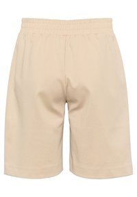 Beige cotton shorts with an elastic waistband, featuring a simple, relaxed fit and a smooth texture. Hemmed at the bottom with no additional details.