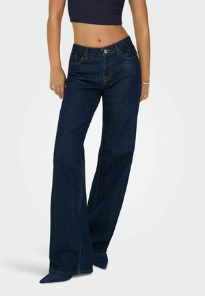 Wijde donkere denim jeans met een hoge taille, voorzien van steekzakken en een subtiele naadverwerking. De stof heeft een soepele textuur en een klassieke afwerking.