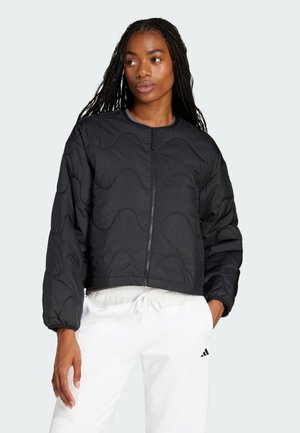 Black quilted cropped jacket with long sleeves, featuring a front zipper and subtle wave pattern; smooth texture and lightweight design.