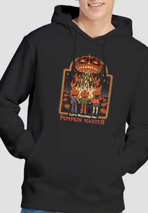 Three children with pumpkin heads holding hands, facing a giant flaming jack-o'-lantern, surrounded by smaller pumpkins and black cat.