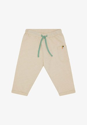 Cremefarbene Baumwoll-Jogginghose mit einem türkisfarbenen Kordelzug und einer seitlichen Tasche mit einem mehrfarbigen Akzent. Mit Bündchen am Saum.