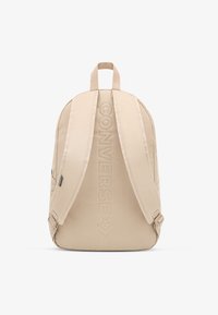 Beežist lõuendist seljakott polsterdatud õlarihmadega, esiküljel reljeefne "CONVERSE" logo ning ülaosas kandekäepide.