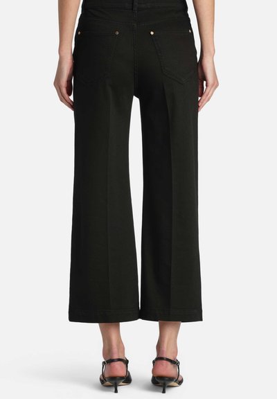 Black wide-leg trousers with a high waist, featuring dual back pockets and gold hardware accents, crafted from a smooth, durable fabric.