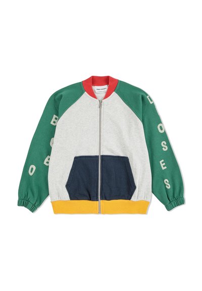 Colorful zip-up jacket with grey body, green sleeves, navy front pocket, and yellow hem. Features raglan design and printed text on sleeves.