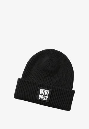 Black knit beanie with a ribbed texture and a folded cuff. Features a rectangular white label with "Mini Boss" in bold lettering.