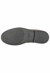 Suola delle scarpe in gomma nera testurizzata, caratterizzata da un motivo ondulato e fori di ventilazione per traspirabilità. Bordo liscio e design piatto.