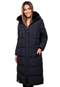 Long black puffer coat with a faux fur collar, zip front, pocket openings, and quilted padding for insulation. Smooth texture and durable design.