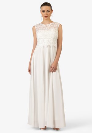 Maxi-jurk met een kanten lijfje en mouwloos ontwerp, vloeiende witte stof met een gladde textuur en een subtiele vloerlange silhouet.