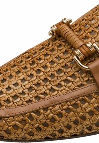 Woven handbag featuring a natural tan color with a textured finish, accented by a smooth leather trim and gold-tone hardware detailing.