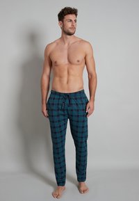 Blue and black plaid lounge pants made from soft fabric, featuring an elastic waistband with a drawstring and a relaxed fit.