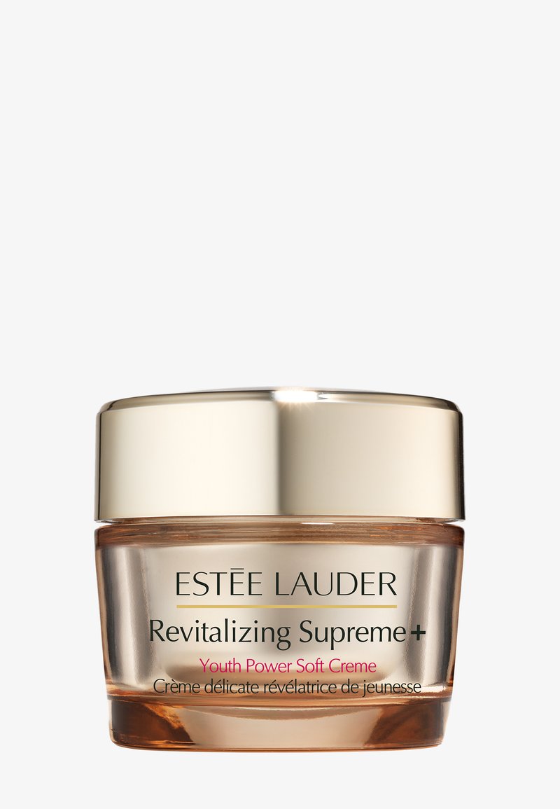Klare Glasdose mit goldenem Deckel, die eine Creme mit der Aufschrift "Revitalizing Supreme+" und "Youth Power Soft Crème" in schwarzem und pinkem Text enthält.