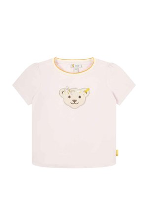 T-shirt rose à manches courtes avec un col rond. Présente un motif de tête d'ours en filigrane avec des accents jaunes. Tissu en coton doux.