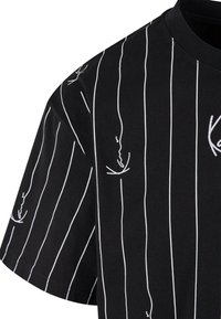 Black t-shirt featuring vertical white stripes and abstract line drawings. Short sleeves and a crew neck design. Made from cotton fabric.