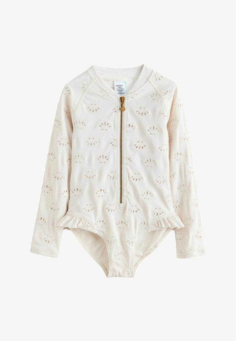 Krémové jednodielne detské plavky s dlhým rukávom s vyšívanými vzormi mušlí, predný zips s ťaháčikom v tvare mušle a drobné volániky na bokoch.