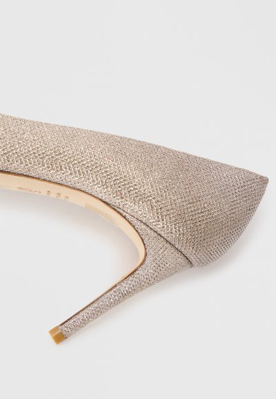 Metallic gold high-heeled pump with textured fabric, pointed toe, and slim stiletto heel; features a fine grid pattern for added detail.