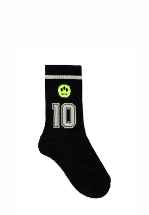 Calzino di cotone nero con texture a coste, presenta una faccina sorridente verde e il numero "10" contornato di grigio, con un bordo rigato bianco.
