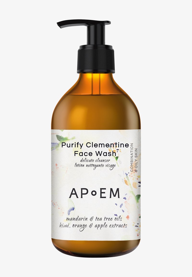 Bärnstenfärgad flaska med svart pumpkork. Etiketten har en blommig design och texten "Purify Clementine Face Wash," som listar ingredienser och hudtyp.