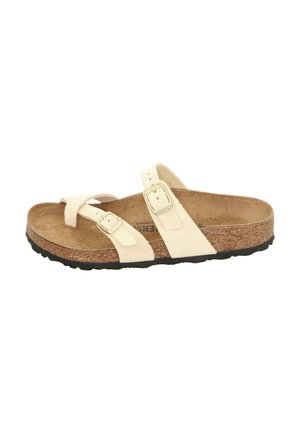 Two-strap sandal in cream leather with adjustable buckles, cork footbed, and black rubber outsole. Smooth texture and minimalistic design.
