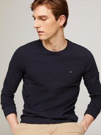 Navy long-sleeve t-shirt made of cotton, featuring a small logo on the chest. The design is simple with a round neckline and fitted sleeves.