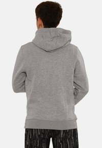 Gray hooded sweatshirt with a soft texture, featuring a kangaroo pocket and ribbed cuffs. The design is simple and fitted.