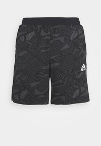 Svarta Adidas träningstoppar med abstrakt grå mönster och elastisk midja, Adidas-logga på högra benet.