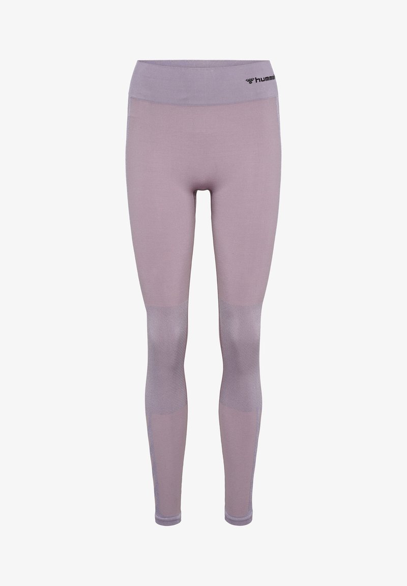 Leggings seamless violet clair avec taille haute et panneaux de genoux texturés, présentant un petit logo hummel noir sur la taille.
