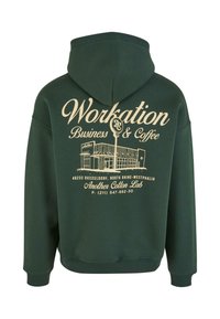 Green cotton hoodie with a back graphic featuring text and a building illustration in beige. Includes ribbed cuffs and hem.
