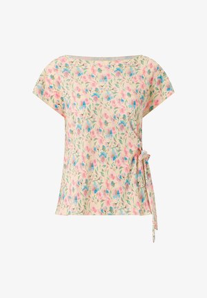 Kortærmet creme top med plisseret stof, lyserødt og blåt blomsterprint og bindebånd i siderne ved højre talje.