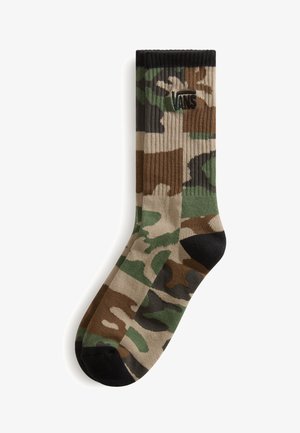 Enkelt sok midt på læggen med kamuflage mønster i grøn, brun, beige og sort samt sort Vans-logo nær den øverste kant.