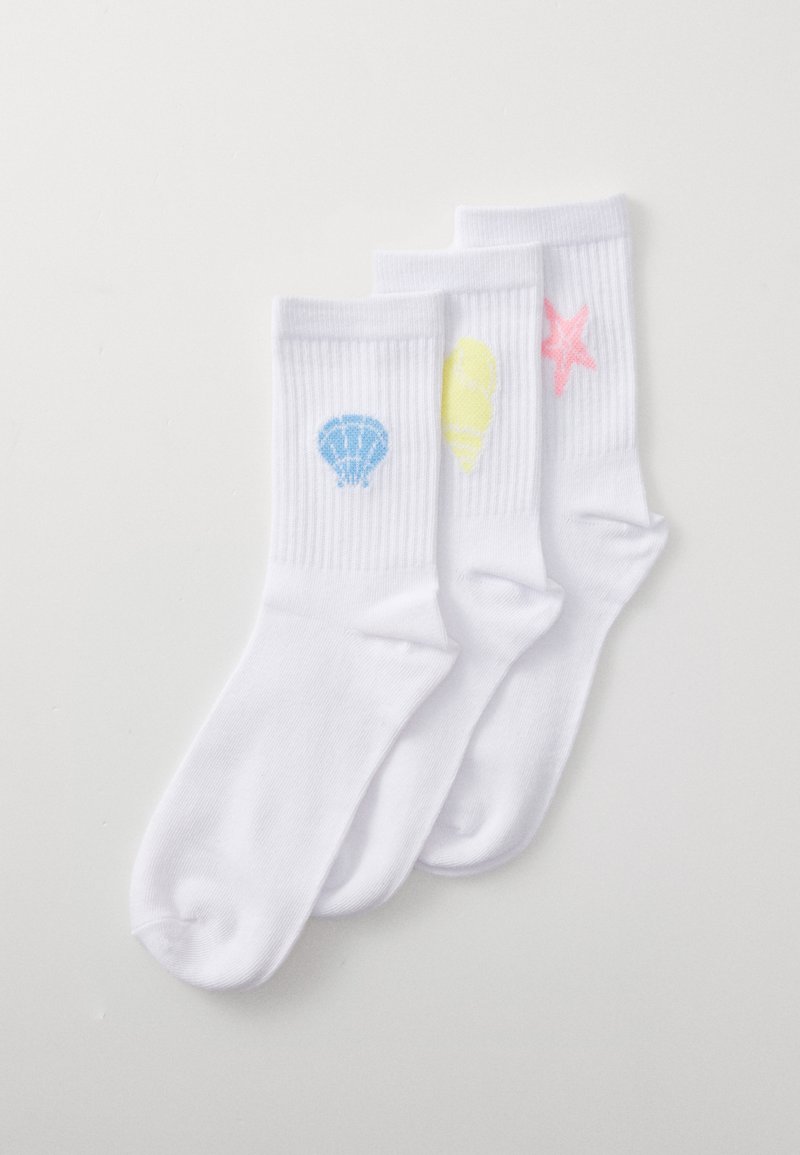 Three pairs of white ankle socks, featuring blue shell, yellow cone, and pink star designs on the front, with ribbed texture.