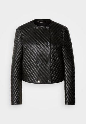 Black quilted leather jacket featuring a round neck, long sleeves, and snap fasteners, with diagonal stitching patterns and a cropped design.