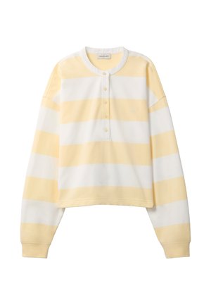 Pull court à manches longues avec rayures horizontales jaunes et blanches, col à boutons et petit logo "cK" brodé sur la poitrine.