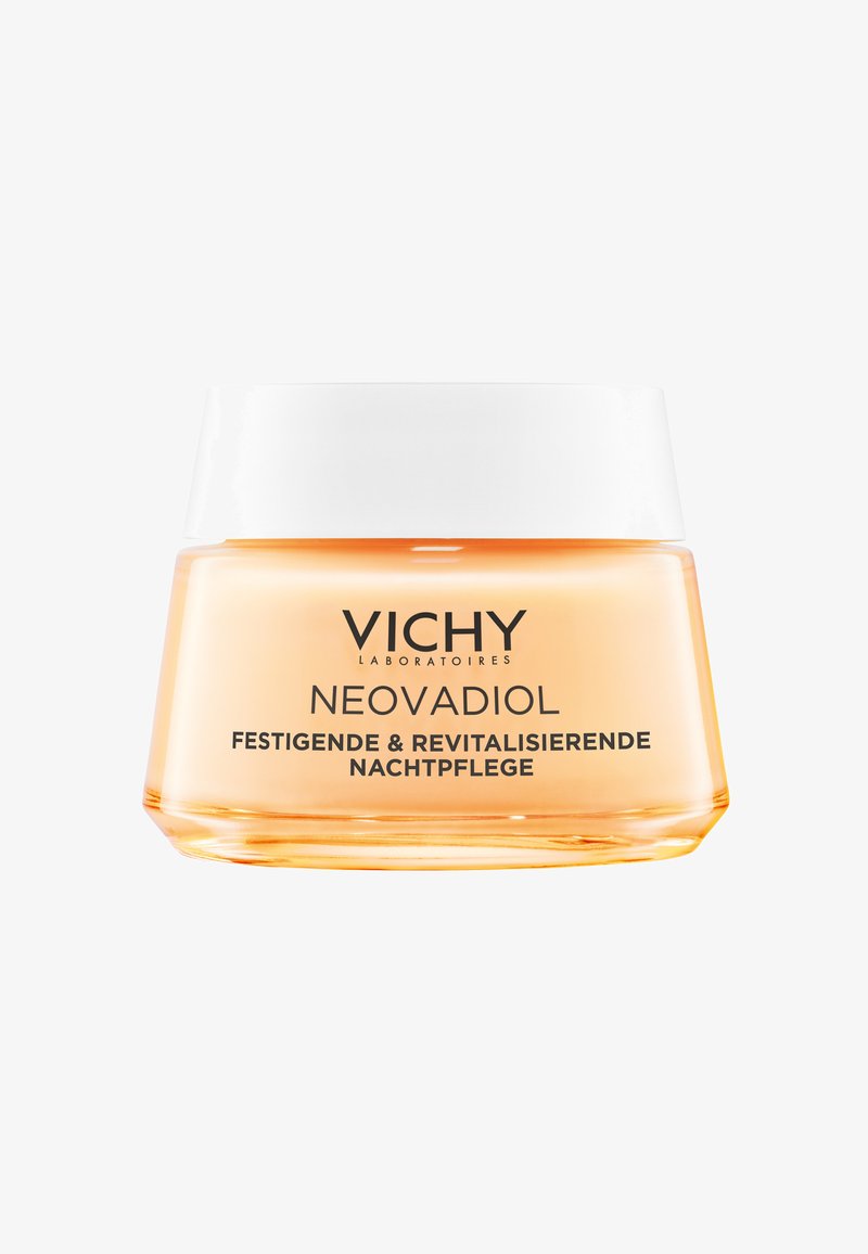 Vichy Neovadiol straffende und revitalisierende Nachtcreme in einem Glas mit weißem Deckel, orangefarbener durchsichtiger Behälter, deutscher Text auf der Vorderseite.