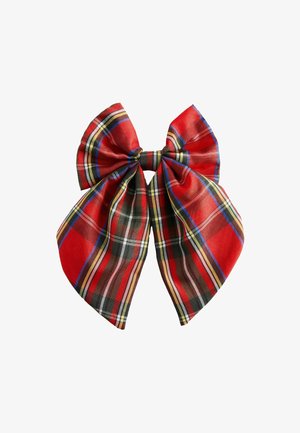 Red plaid fabric bow with large loops and tails, featuring black, yellow, blue, and white stripes. Smooth texture and symmetrical design.
