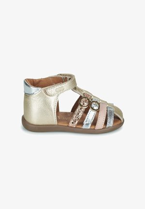 Toddler’s multi-strap sandal in gold, silver, pink, and bronze tones with two small buckles and a brown sole.