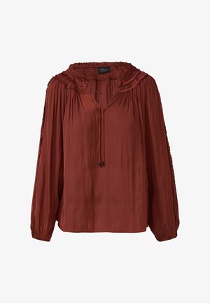 Rostevärviline blouse, millel on plekitud kaelus ja pikad varrukad. Pehme, voolav kangas V-kaelusega ja ees joonistusdetailiga.