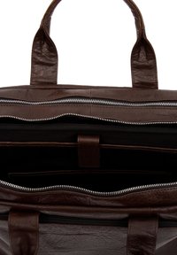 Brun skinn tote veske med doble håndtak, som har glidelås, flere indre lommer og en myk, teksturert overflate.