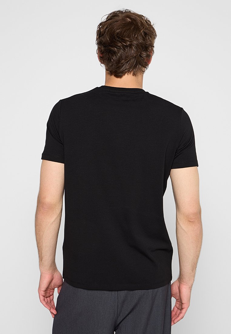 Camiseta negra de manga corta en mezcla de algodón con cuello redondo, con textura suave y un diseño ajustado, mostrada desde la parte de atrás.