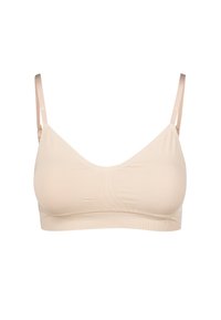 Beige trådlös bh med slätt tyg, minimalistisk design, justerbara axelband och subtila sömnadsdetaljer. Mjuk, sömlös konstruktion.
