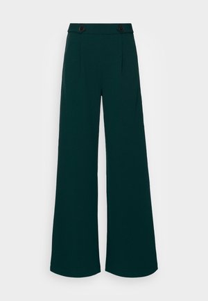 High-waist dark green wide-leg trousers with two black buttons on the waistband, tailored with front creases.
