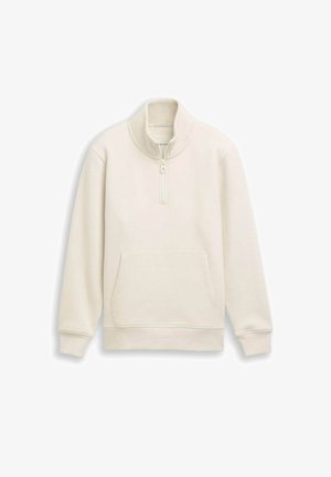 Sweat-shirt crème à col haut, zip quart et poche kangourou sur le devant. Texture douce et poignets côtelés.