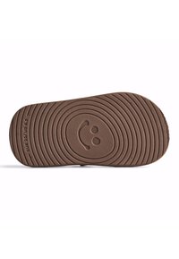 Suola in gomma marrone con motivi di battistrada circolari e un dettaglio a forma di faccina sorridente. Il testo include "EUR 25/US 8.5" e "5.5."