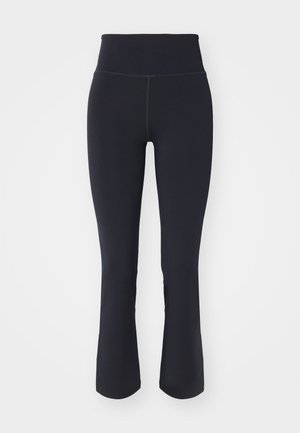 Black flared leggings with a high waistband, made of stretchy fabric. Features flat seams and a smooth texture.