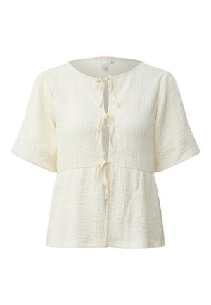 Crèmekleurige textuurbloes met korte mouwen, een ronde halslijn en drie knoopsluitingen aan de voorkant, met een losse, licht uitlopende pasvorm.