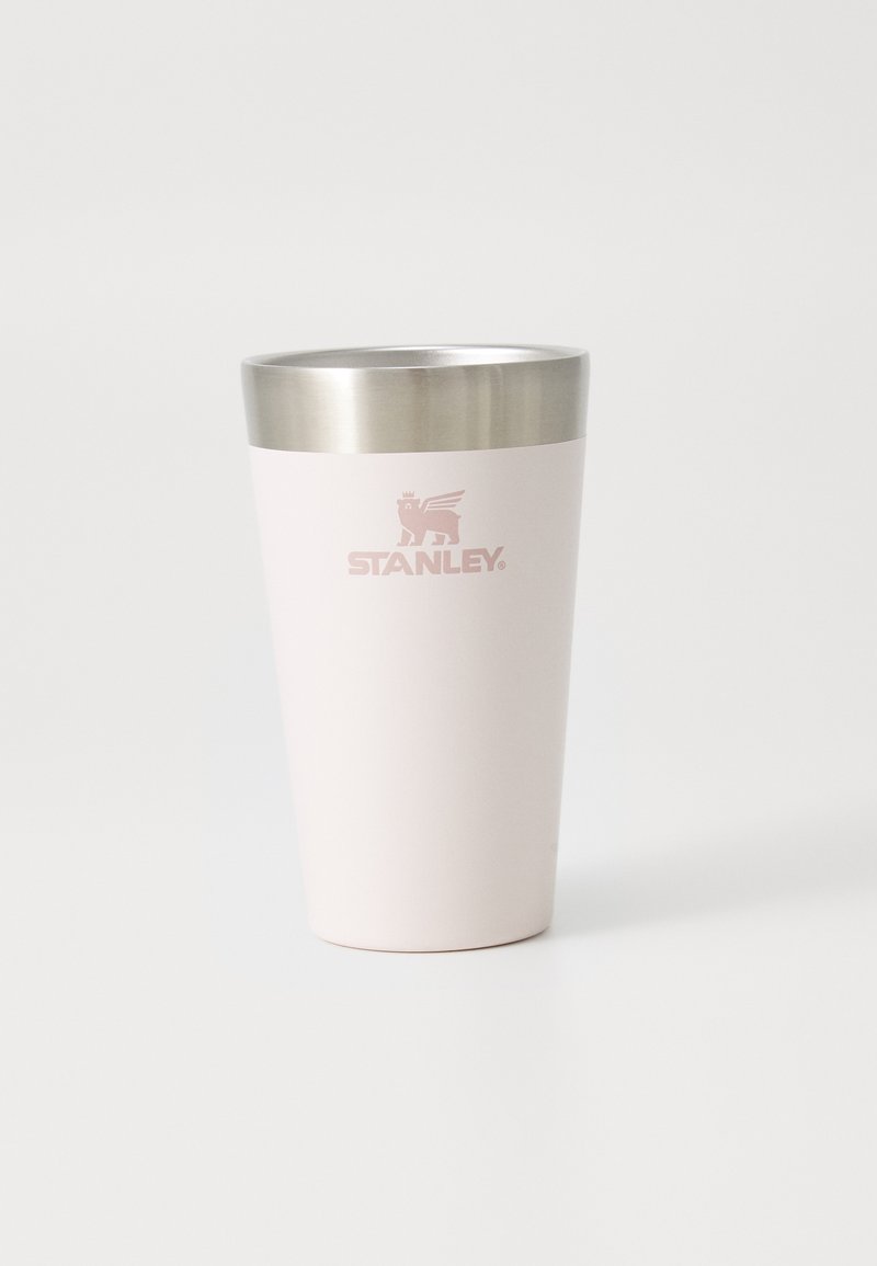 Stainless steel tumbler with a light pink matte finish and a silver metal lid. "STANLEY" logo embossed in pink on the front.