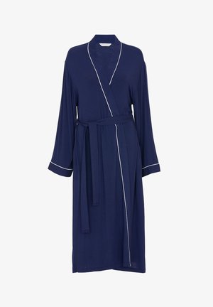 Robe bleu marine en tissu doux, avec des manches longues, une ceinture à la taille et un passepoil blanc le long du col et des manches.