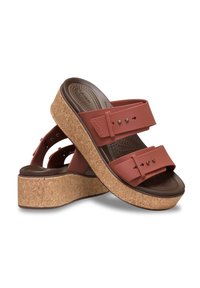 Brown cork platform sandals with maroon rubber straps, featuring adjustable buckles and molded footbed for comfort.