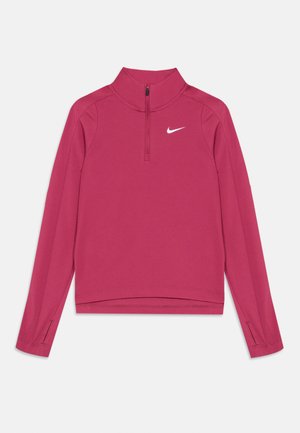 Ružový Nike pulóver s vysokým golierom, polozipsom, dlhými rukávmi a otvorom na palce. Vyrobený z hladkého, elastického materiálu. Biely logo na hrudi.